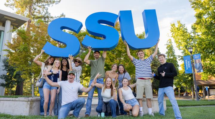 Students holding large SSU letters